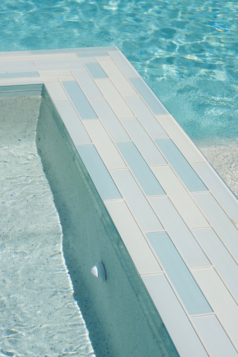 Closeup of turquoise mosaic tile pool ledge in Dallas, TX