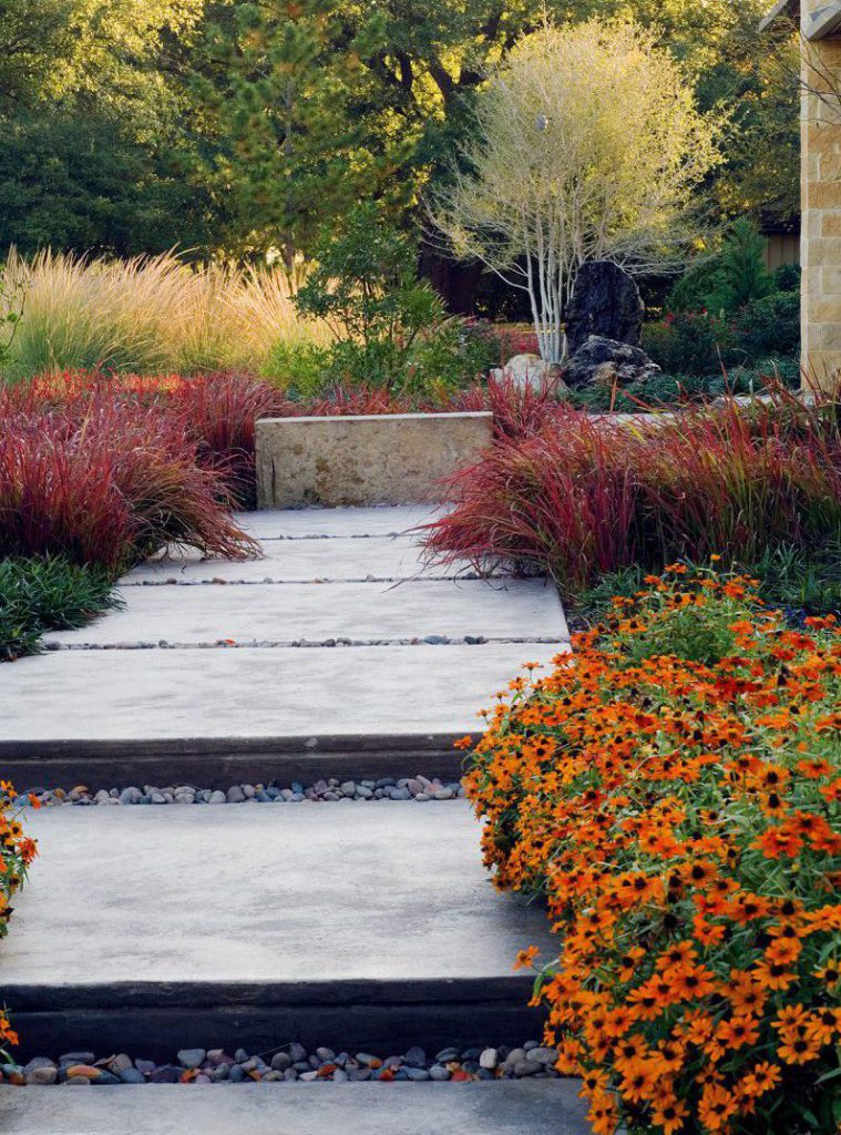contemporary walkway with concrete pavers and seasonal color landscaping