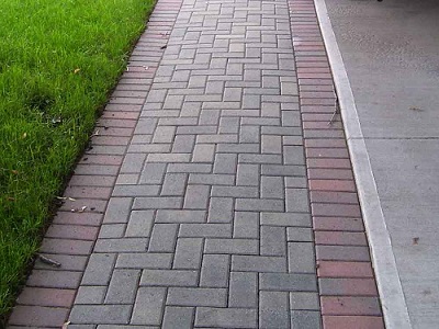 Close-up of a walkway made using concrete pavers that look like brick.
