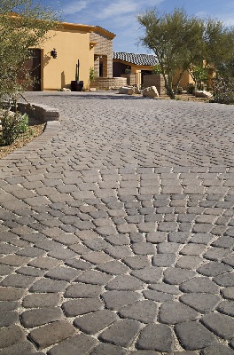 Close-up of a driveway made using grey concrete pavers.