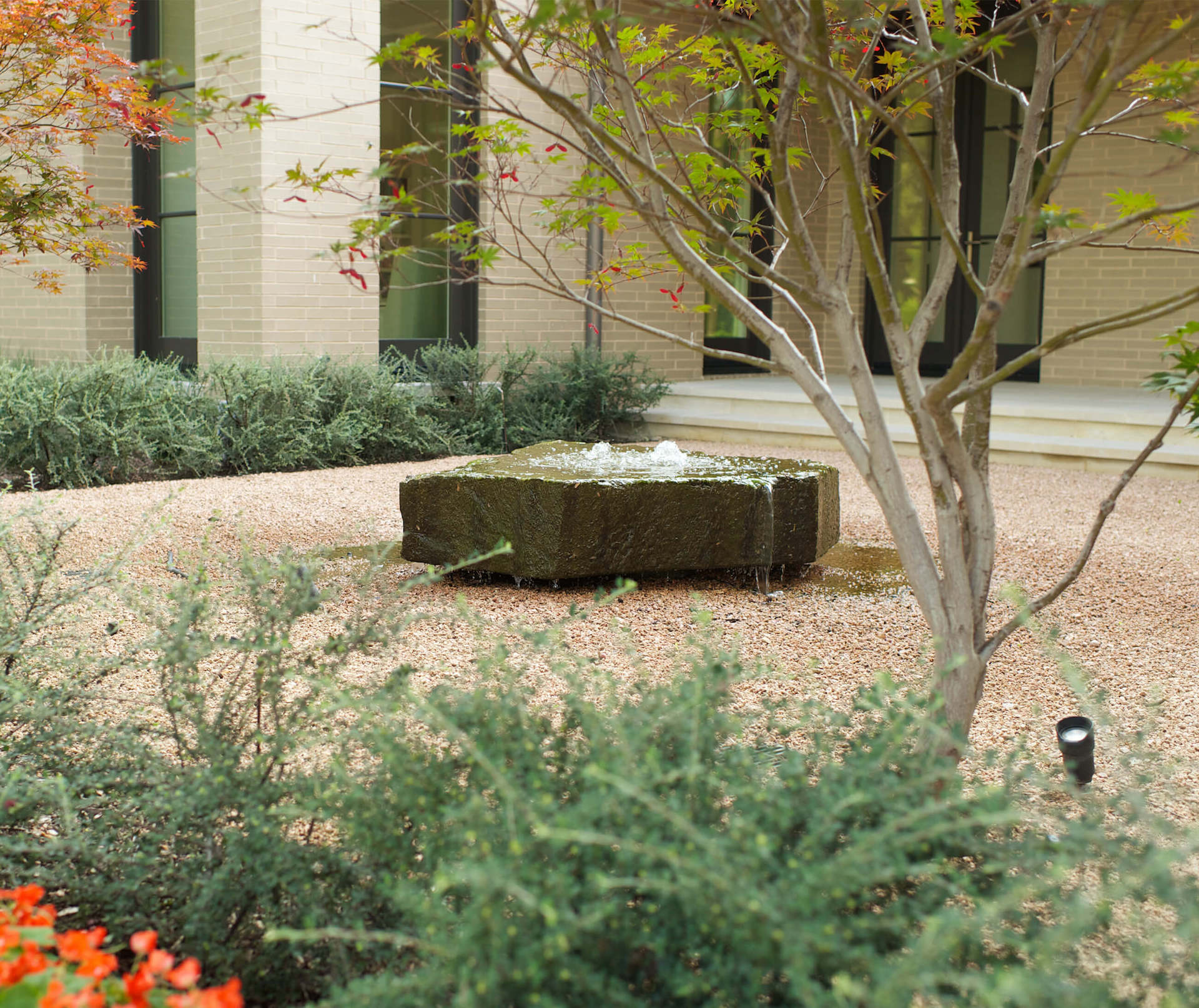 Dallas, TX - Crestbrook Boulder Water Feature in gravel courtyard