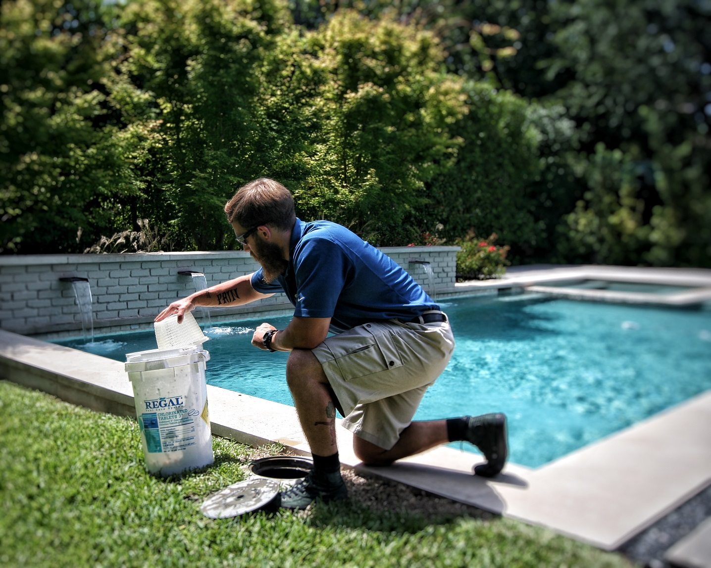 Pool maintenance technician cleaning a pool.