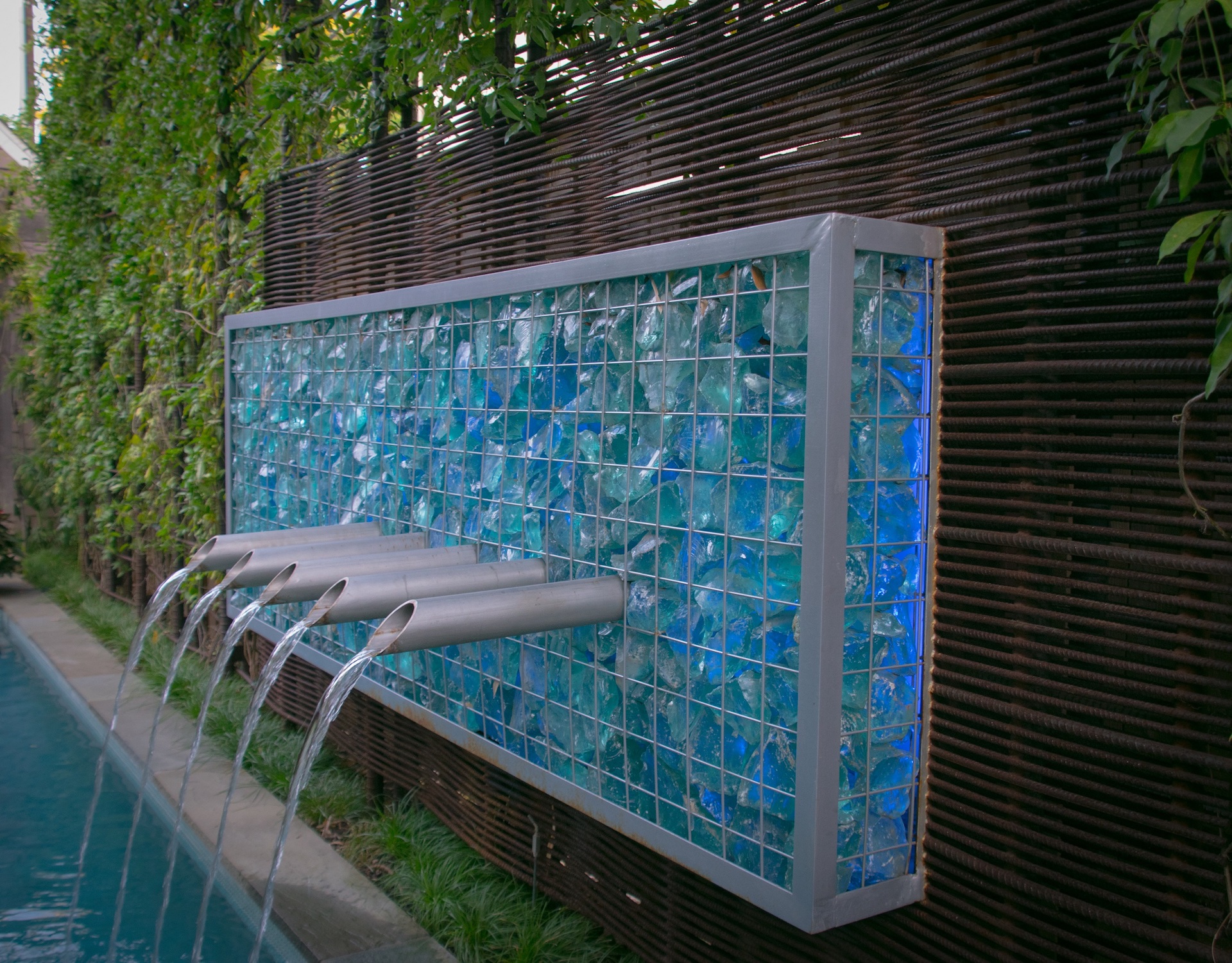 Close up of water feature of pool scuppers.
