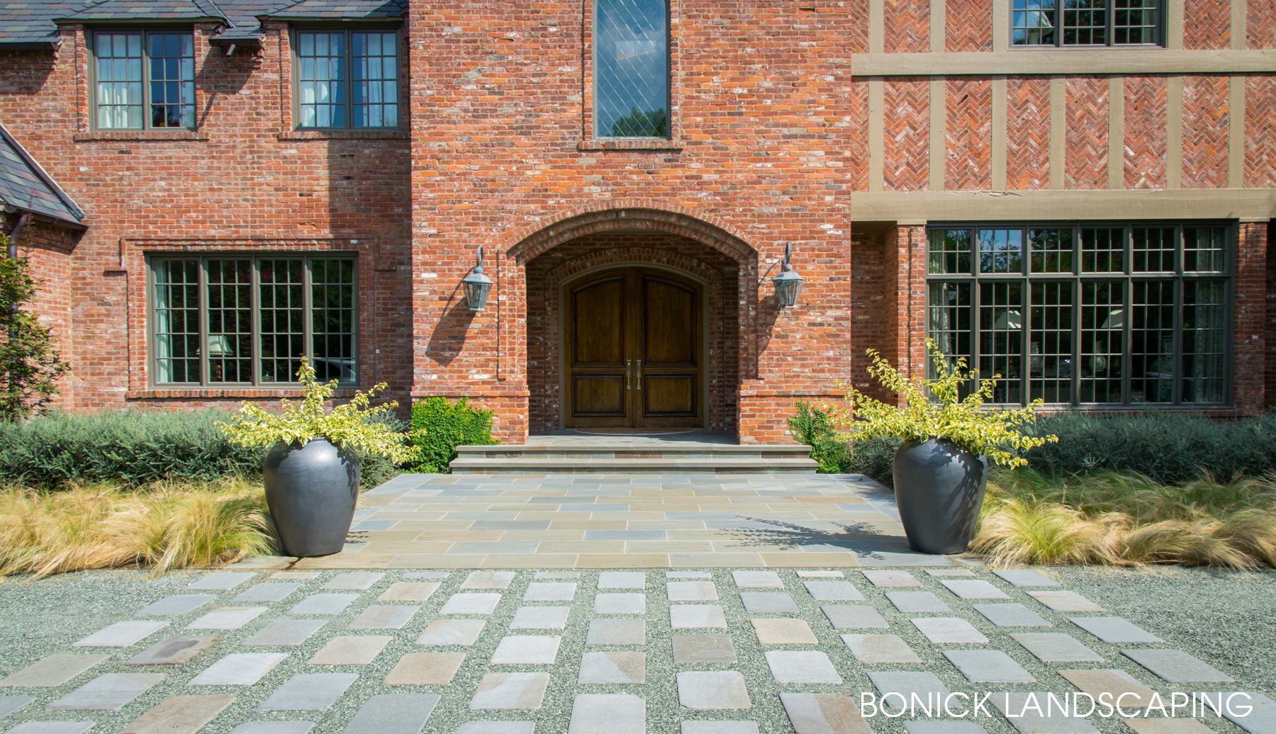 Front entryway to Dallas home features striking landscape design elements using natural stone and gravel.