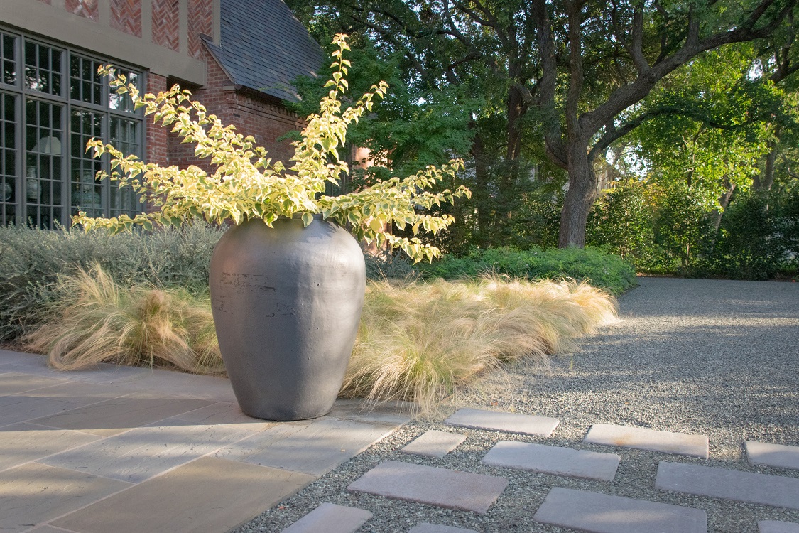 Crushed marble drive and Pennsylvania bluestone walkway and driveway pavers help tie the landscape to the home.