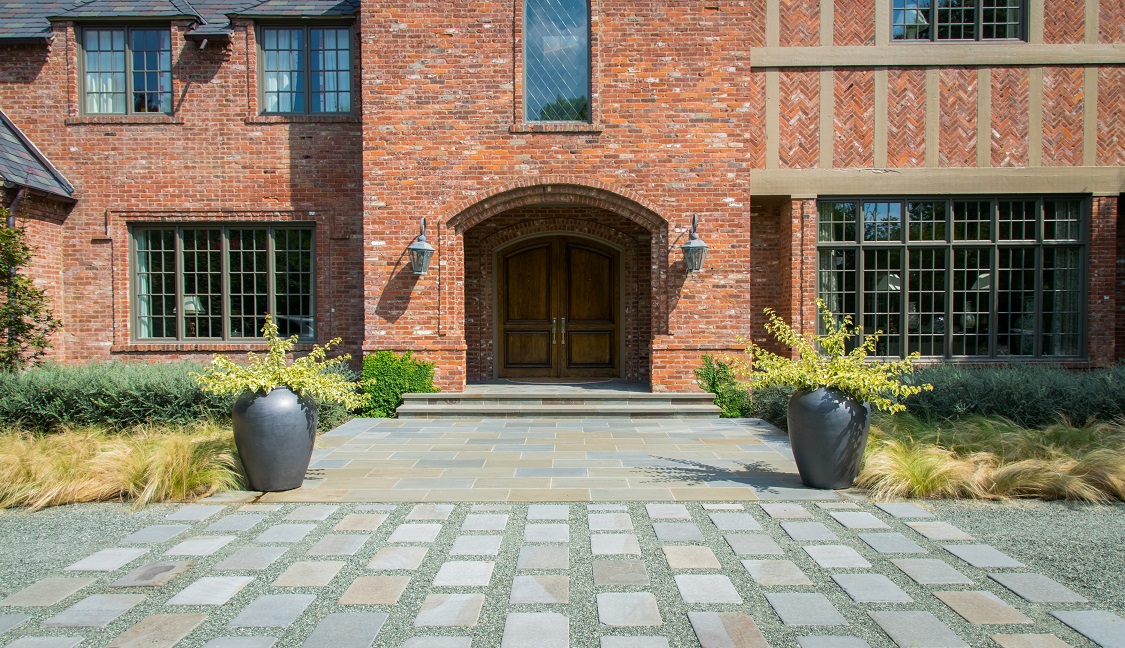 Tudor home entry with modern hardscaping elements.