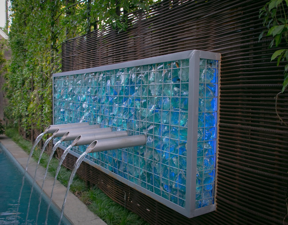 Modern fountain features large chunks of blue slag glass.