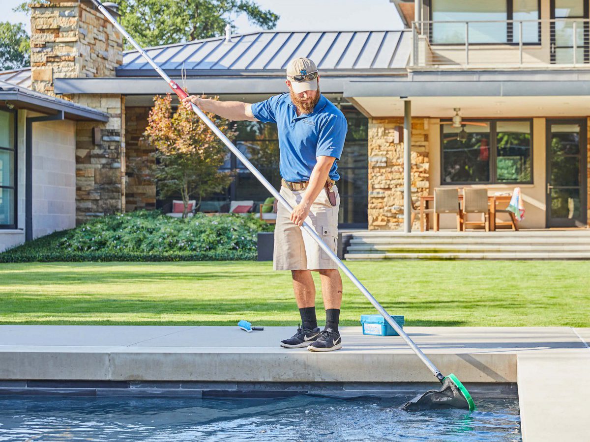 Pool cleaning of contemporary luxury pool by Hocker Design Group in Dallas, TX